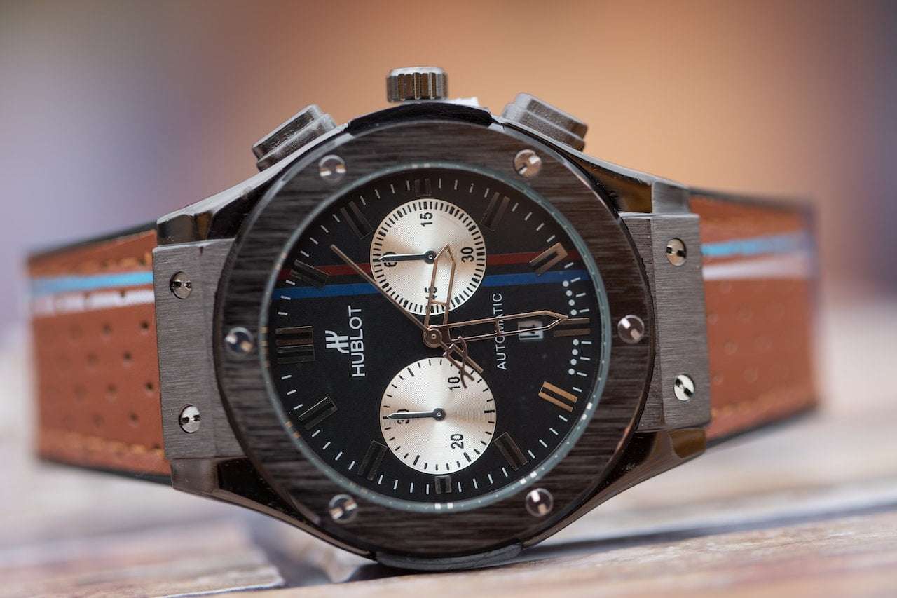 Hublot watch with black face and brown straps