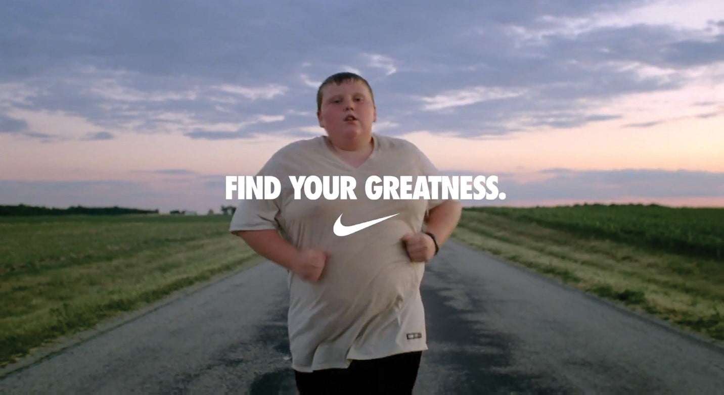 Obese teenager is running trying to lose weight. The advertisement states Find your greatness and nike logo