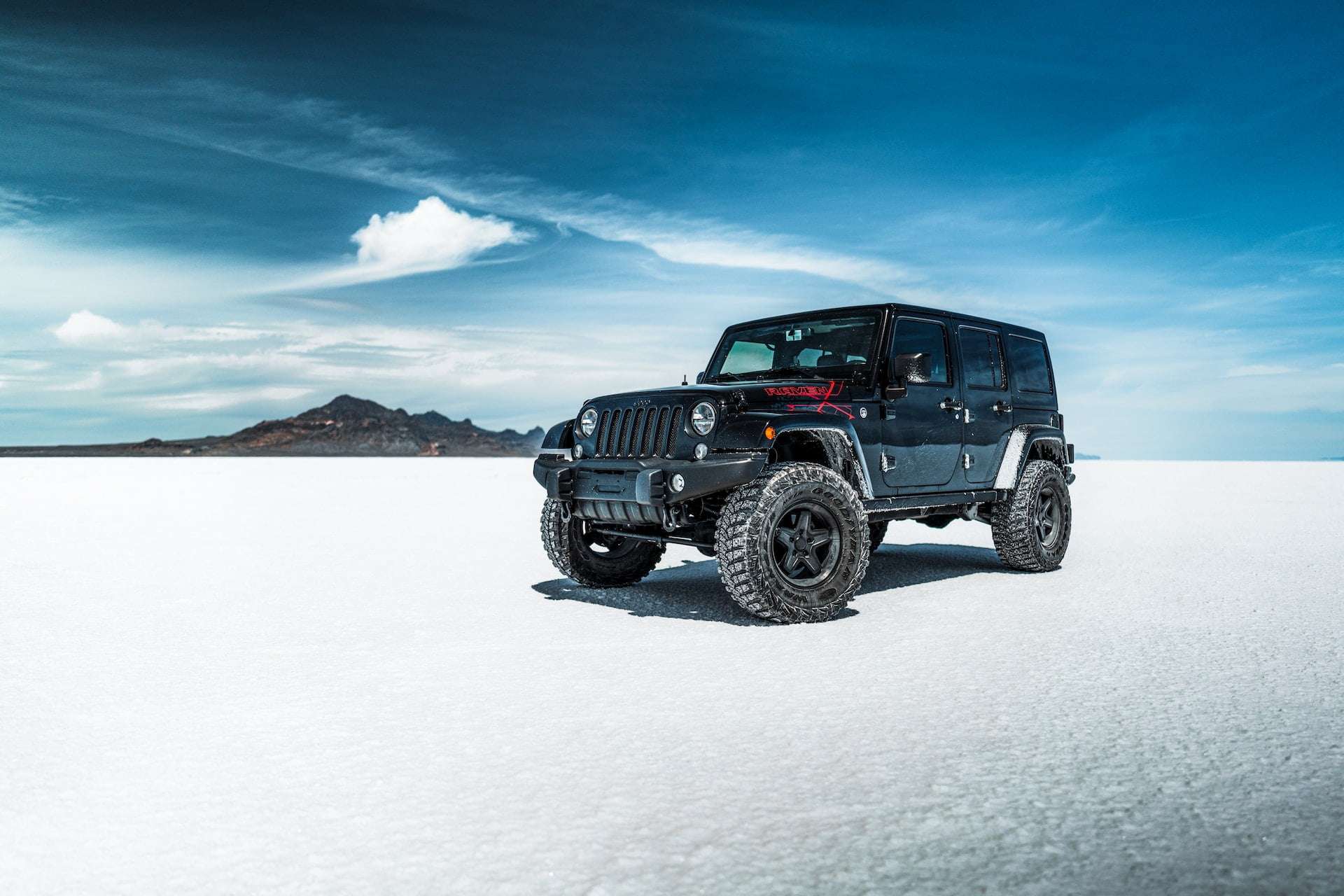 Black jeep in the middle of salt desert