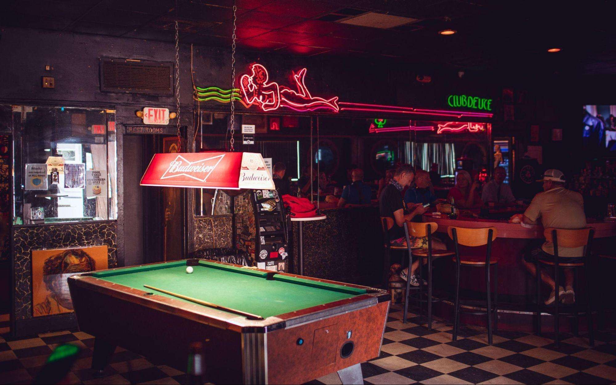 Budweiser brand logo above pool table
