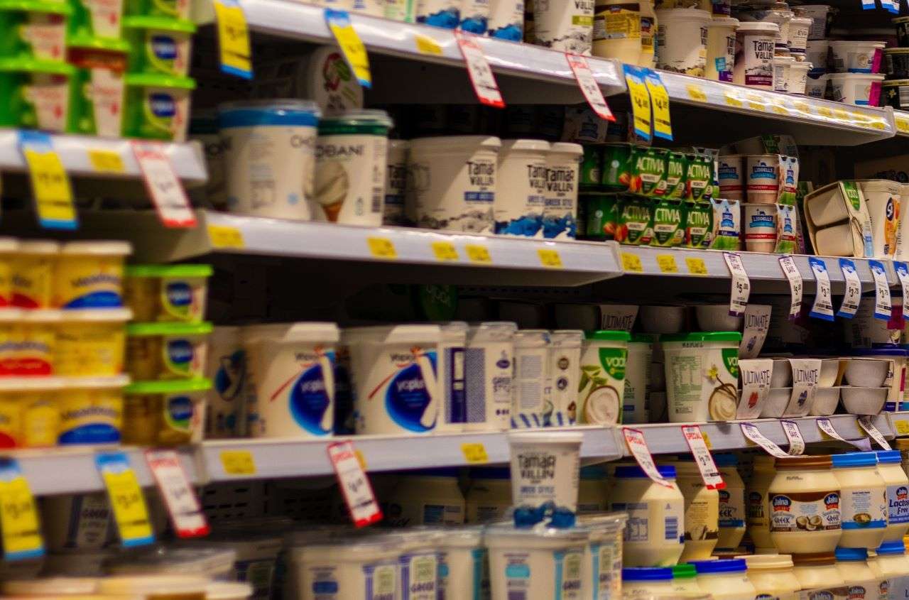 Inside supermarket with shelves with milk products such as yogurt