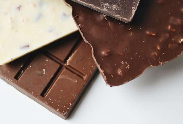 Three premium chocolate bars with nuts in milk chocolate or dark chocolate or white chocolate