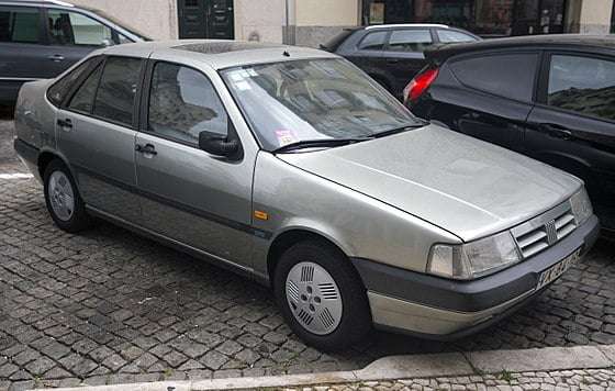 A grey coloured fiat tempra parked on the street