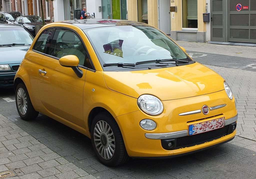 A yellow Fita 500 parked on the street