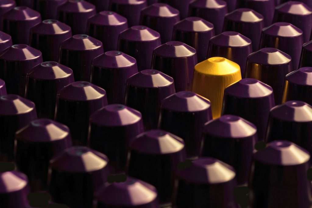 Nespresso capsules all purple but one yellow capsule