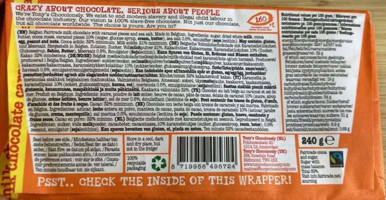 The back of a Tony’s Chocolonely chocolate bar in orange wrapping. This is the salted caramel chocolate bar.