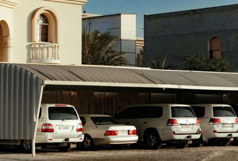 Three Toyota Land Cruisers and one Lexus parked in a garage.