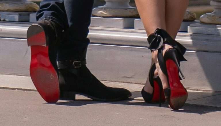 Male and female Louboutin shoes showing the red soles
