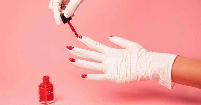 Dior red nail polish applied on a person's hand