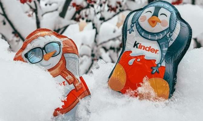 Two Kinder chocolate figures a penguin and snowman