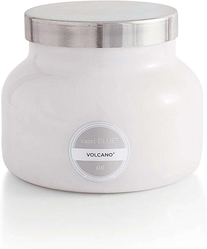 Candle , blending tropical fruits and sugared citrus in a white jar.