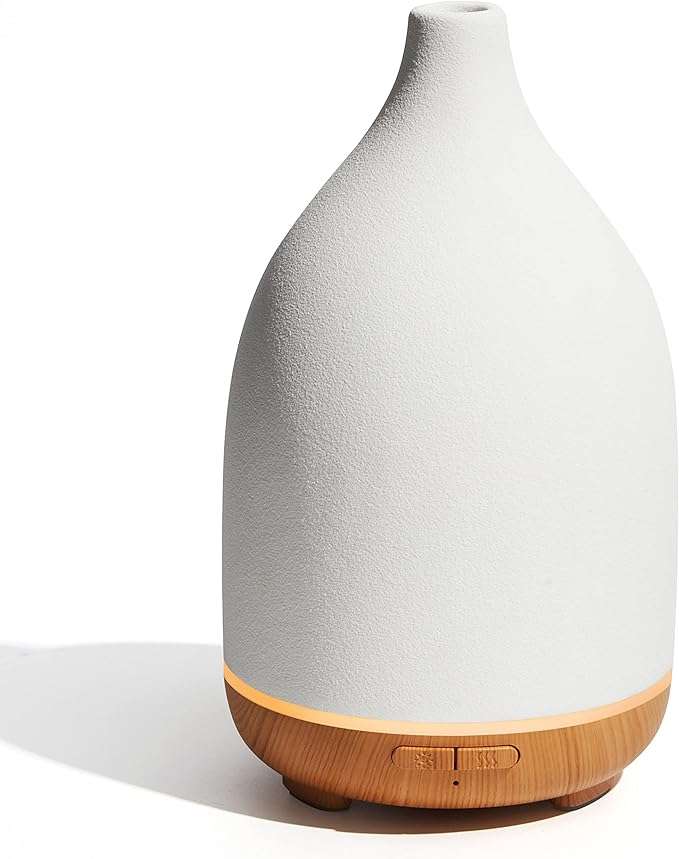 A white handcrafted ceramic diffuser offers aromatherapy relaxation and cool mist humidification