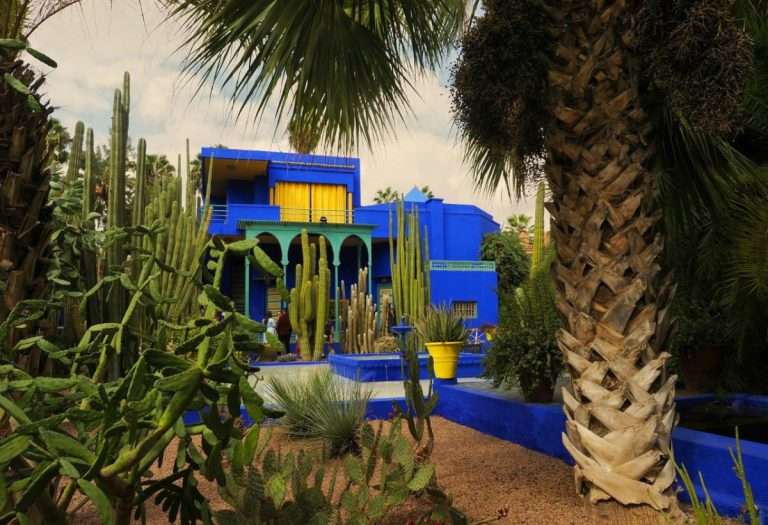 Photo of the blue and yellow exterior of the Yves Saint Laurent Museum in Marrakech, Morocco. This showcases bold architectural lines and vibrant colors inspired by Moroccan design by YSL